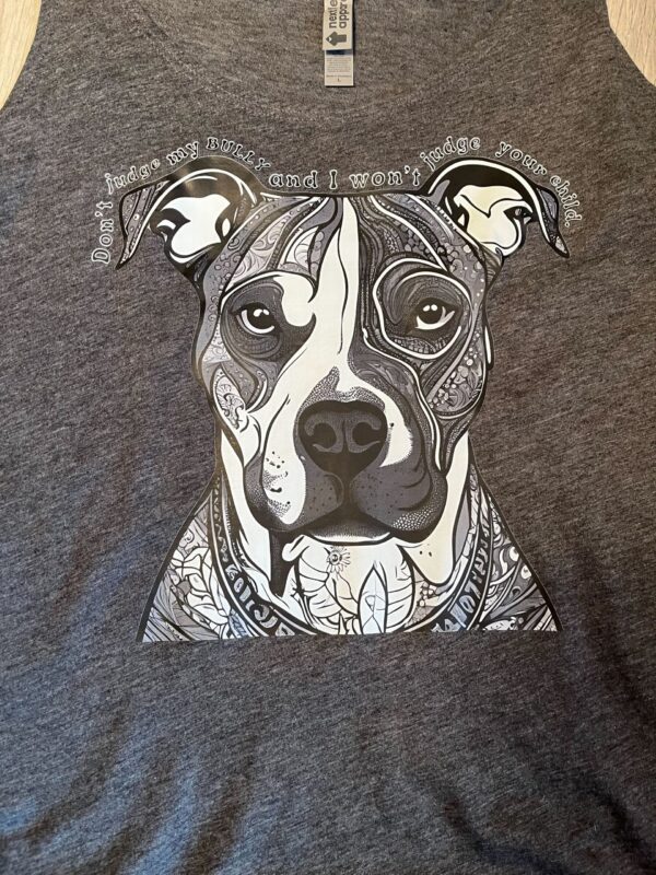 Dark heather charcoal t-shirt featuring a large black and white mandala-patterned bully breed dog face with the text "Don't judge my Bully and I won't judge your child" arched above.