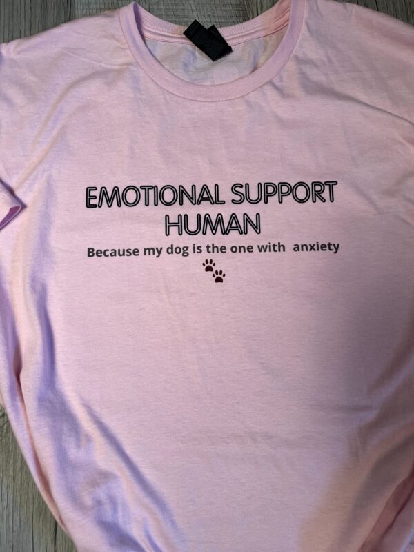 Light pink unisex t-shirt with black text that reads "Emotional Support Human - Because my dog is the one with anxiety" alongside two small paw prints. Supporting Bogey's Buddies animal rescue.